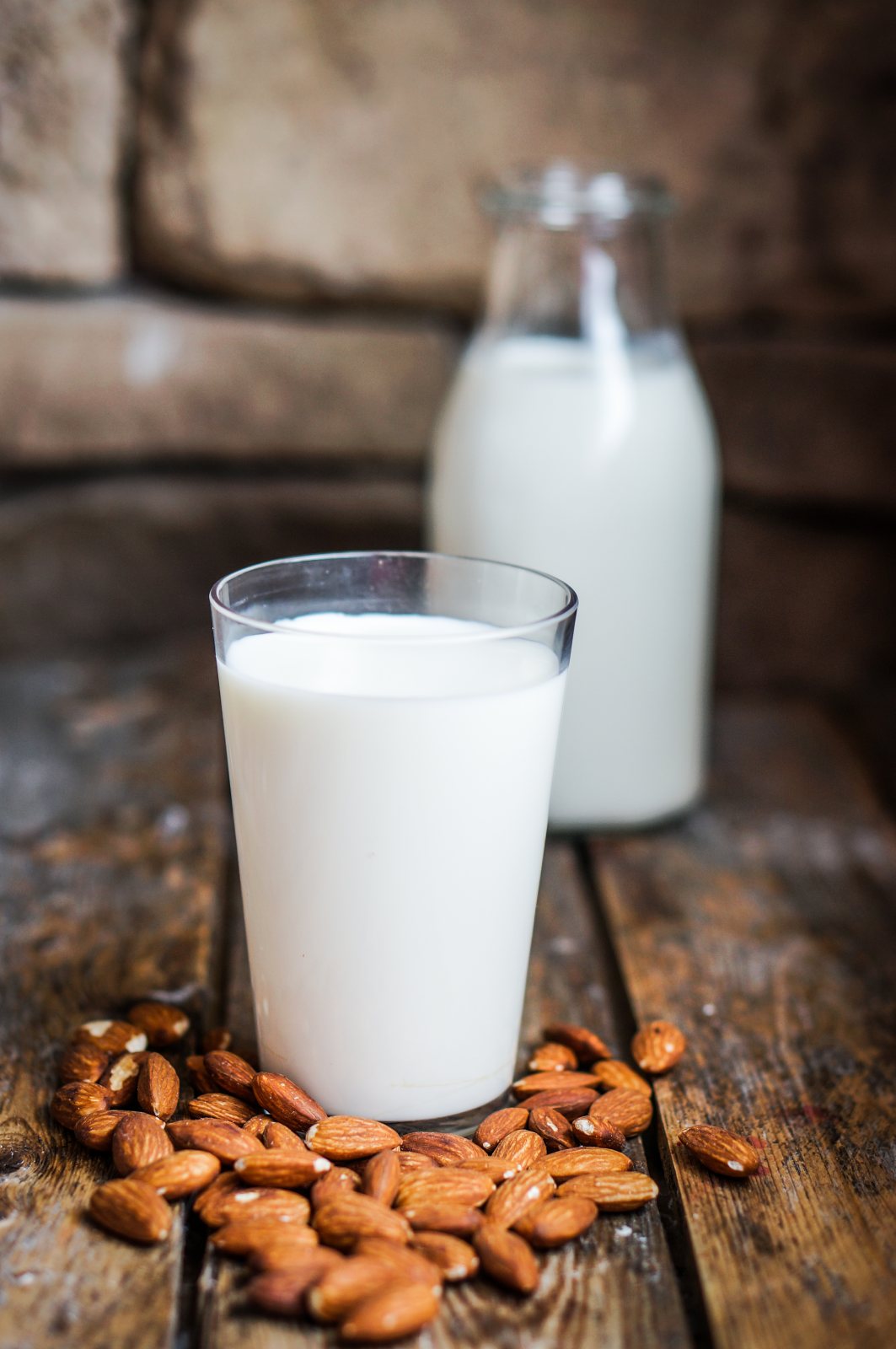 Almond milk on rustic wooden table